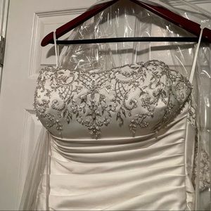 Wedding dress, beaded with buttons down the back and a train. Rouging on side